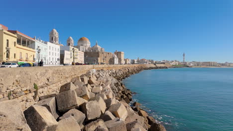 Coastal-cityscape-with-clear-blue-sky,-historical-buildings,-and-calm-sea,-daytime