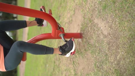 A-Lady-Utilizing-Fitness-Equipment-Outdoors-in-the-Park---Vertical-Shot