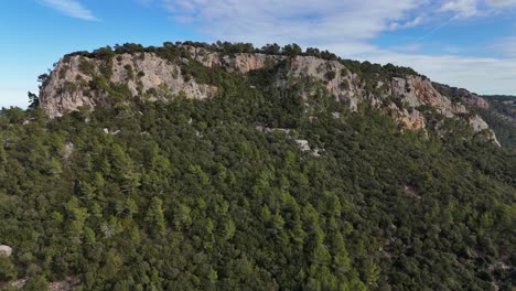 Drone-shot-of-the-forest-hill-in-Esporles-valley-on-the-island-village-of-Mallorca-in-the-Serra-de-Tramuntana,-Spain