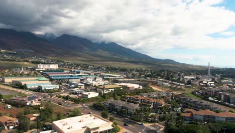 Hawaii-island-mountains-and-township-of-Lahaina,-aerial-ascend-view