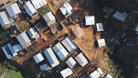 Top-down-drone-shot-flying-over-a-less-wealthy-neighborhood-of-Valparaíso,-Chile