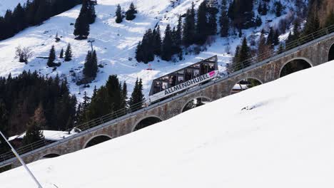 Mountain-funicular-railway-system-with-arch-holes,-snowy-Switzerland-nature