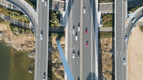 An-aerial-bird's-eye-perspective-captures-the-Shandong-Province-Linyi-Bridge-over-the-Benghe-River-in-China,-with-flowing-car-traffic-beneath-the-daytime-sunshine