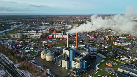 Industrial-factory-in-small-township,-aerial-drone-view