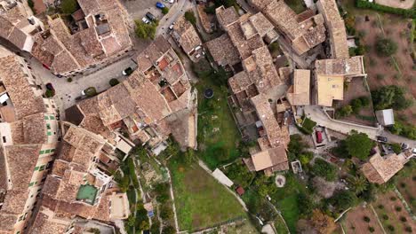 Traditional-village-of-Valldemossa-on-the-Tramuntana-mountain,-Mallorca,-Balearic-Islands,-Spain-drone-top-shot
