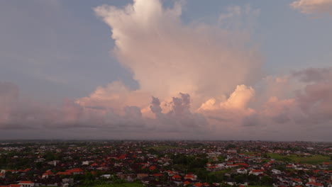 Villas-in-Canggu-village-countryside-with-cloud-sky-at-sunset,-Bali-in-Indonesia
