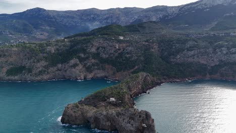 Aerial-backwards-shot-of-beautiful-mountain-range-and-Mirador-de-sa-Foradada-in-Mallorca