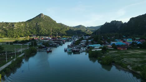 Drone-moving-towards-Bang-Pu-Fishing-Village-revealing-this-complete-landscape,-Sam-Roi-Yot-National-Park,-Prachuap-Khiri-Khan,-Thailand