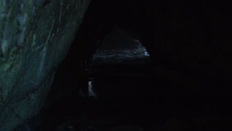 Mesmerizing-footage-of-water-breaking-through-a-captivating-cave,-nature's-enchanting-spectacle