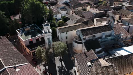 Aerial-view-above-french-medieval-town-Valergues,-scenic-urban-cityscape,-traditional-architectural-buildings