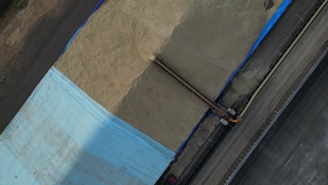 Grain-unloading-for-distribution-industry.-Aerial-top-down-orbiting