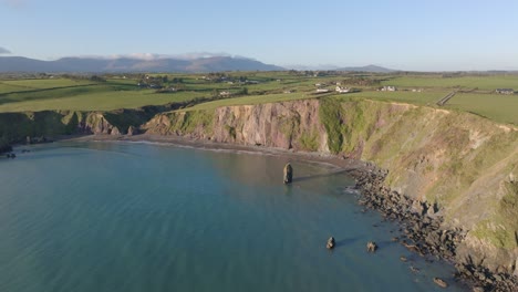 Drone-landscape-sea-and-mountains-at-Ballydwane-copper-Coast-Waterford-Ireland-on-a-calm-morning