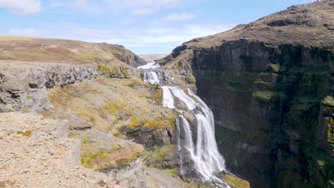 Strong-water-stream-falling-down-over-the-Glymur-waterfall-in-Iceland-on-a-sunny-day