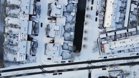 Top-down-aerial-of-a-beautiful-street-with-homes-covered-in-snow