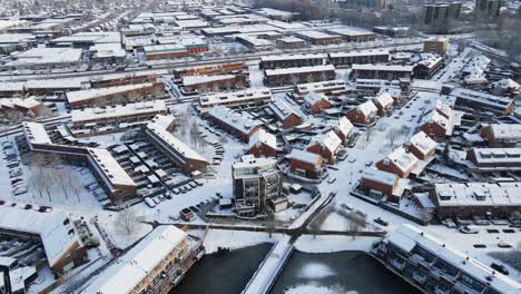 Cinematic-aerial-of-a-beautiful-suburban-neighborhood-covered-in-snow-on-a-sunny-day