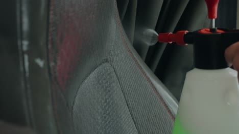 Up-close-deep-clean-valeting-of-auto-cloth-seat-using-chemical-spray