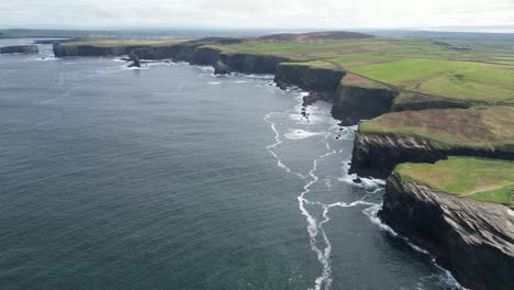 Wide-aerial-shot-of-the-coastal-farm-fields-landscape-of-the-Kilkee-Cliffs-in-County-Clare-Ireland