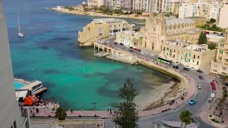 Panoramic-view-of-the-Balluta-Bay-and-Parish-Church-of-Our-Lady-of-Mount-Carmel-in-Saint-Julians,-Malta