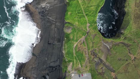 Aerial-shot-of-ocean-cave-in-the-Kilkee-Cliffs-in-the-countryside-of-Ireland