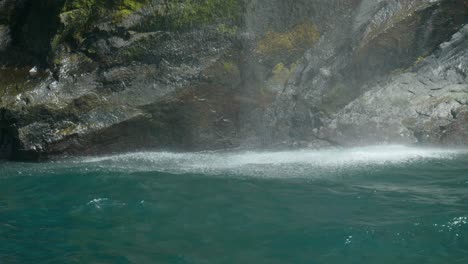 Dramatische-Wasserkaskade-Am-Klippenfuß-Des-Milford-Sound,-Eine-Atemberaubende-Szene-Der-Kraft-Und-Schönheit-Der-Natur