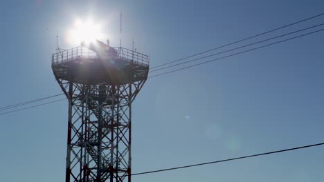 Backlit-view-of-a-communications-tower-against-a-clear-blue-sky,-in-an-airport-in-Argentina