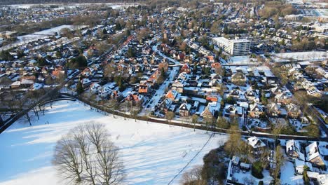 Beautiful-Aerial-of-a-large-snow-covered-park-in-a-wealthy-and-affluent-neighborhood-in-the-Netherlands