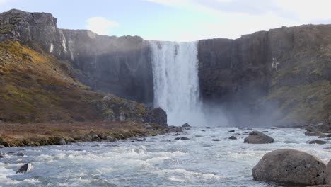 Water-falling-down-over-a-high-waterfall-Seydisfjordur-i-nIceland-on-a-sunny-day