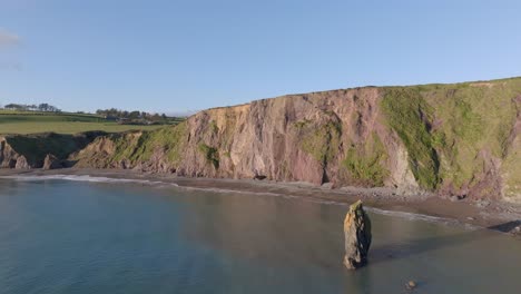 drone-static-sea-cliffs-and-sea-stack-at-full-tide-Copper-Coast-Waterford-Ireland