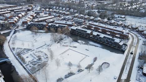 Beautiful-aerial-of-a-snow-covered-park-in-the-middle-of-a-suburban-neighborhood-in-the-Netherlands