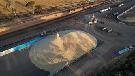 Aerial-view-of-unloading-cargo-truck,-transport-grains-on-heap-with-belt-conveyor