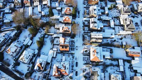 Aerial-of-snow-covered-and-clean-streets-in-a-wealthy-suburban-neighborhood-on-a-sunny-winter-day
