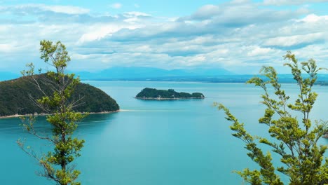 Scenic-view-of-two-islands-framed-by-lush-trees-in-Abel-Tasman-National-Park,-a-nature-lover's-paradise