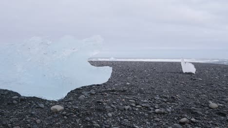 Blue-ice-blocks-at-Diamond-beach-in-Iceland-on-a-cloudy-day