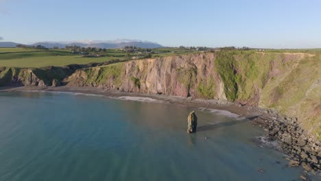 static-drone-shot-sea-stack-and-Ballydwane-beach-Copper-Coast-Waterford-Ireland-dramatic-cinematic