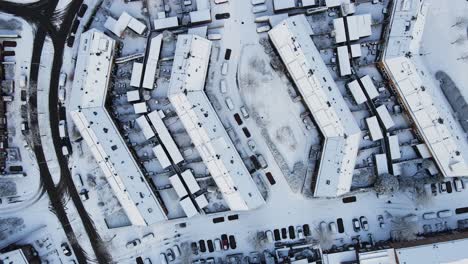 Top-down-aerial-of-a-snow-covered-neighborhood-in-a-small-town