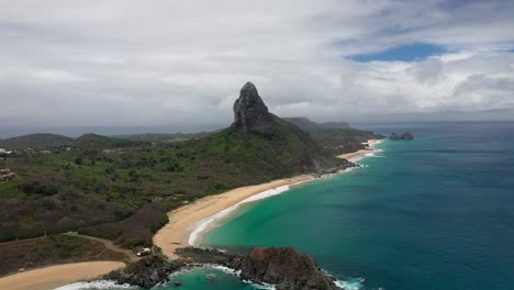 Drone-view-of-Morro-do-Pico-with-beach-and-sea-in-the-background-in-Fernando-de-Noronha,-Brazil