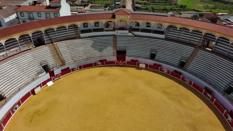 Pozoblanco-Bullring-in-Cordoba,-showcasing-the-arena-and-seating-under-clear-skies,-aerial-view