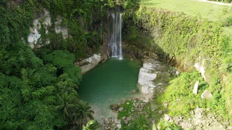 Take-off-from-this-magical-place,-a-waterfall-with-a-pond-surrounded-by-jungle