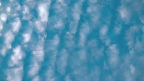 A-beautiful-time-lapse-from-below,-surfing-white-clouds,-blue-sky,-daylight-sun,-4k-static-video