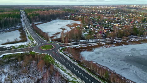 Aerial-Drone-Above-suburban-landscape-in-winter-with-the-sky-highway-roundabout