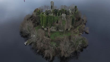 McDermott-Castle-on-an-island-in-Lough-Key,-County-Roscommon,-Ireland,-at-dusk,-tranquil-and-historic,-aerial-shot