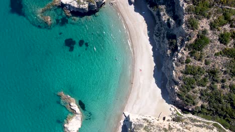 Aerial-Wide-Top-View-of-Tourists-Enjoying-the-Kaladi-Beach-with-Crystal-Clear-Waters,-Greece