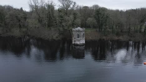 Temple-at-Lough-Key,-an-old-lakeside-structure-in-Roscommon,-Ireland,-surrounded-by-trees