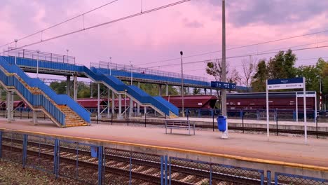 Beautiful-pink-sunrise-sky-at-the-Chelm-train-station-in-Poland,-early-morning,-4K-shot
