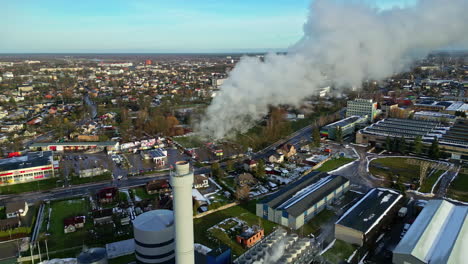 Industrial-area-with-smokestacks,-buildings,-and-vibrant-activity,-clear-skies