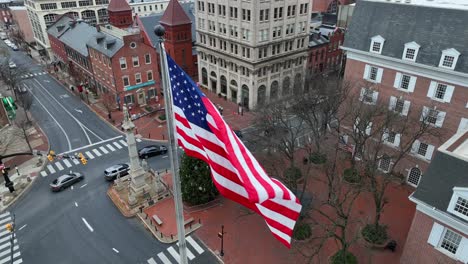 Aerial-close-up-of-American-flag-waving-on-windy-winter-day