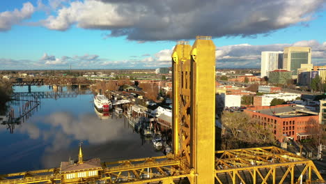 Aerial-view-away-from-the-tower-bridge,-in-sunny,-fall-evening-in-Sacramento,-USA