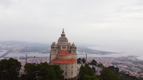 Viana-do-Castelo-city-and-beautiful-Santa-Luzia-church-in-foreground,-aerial-drone-view