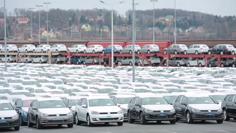 Vast-car-parking-lot-filled-with-new-vehicles,-distribution-hub-for-automobiles
