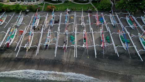 Drone-close-up-panning-shot-of-hundred-of-identical-and-traditional-hand-made-fishing-boats-on-a-beach